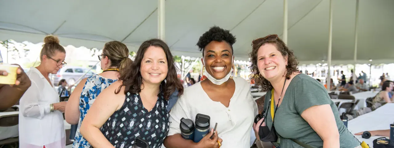 Three staff members at an employee picnic.